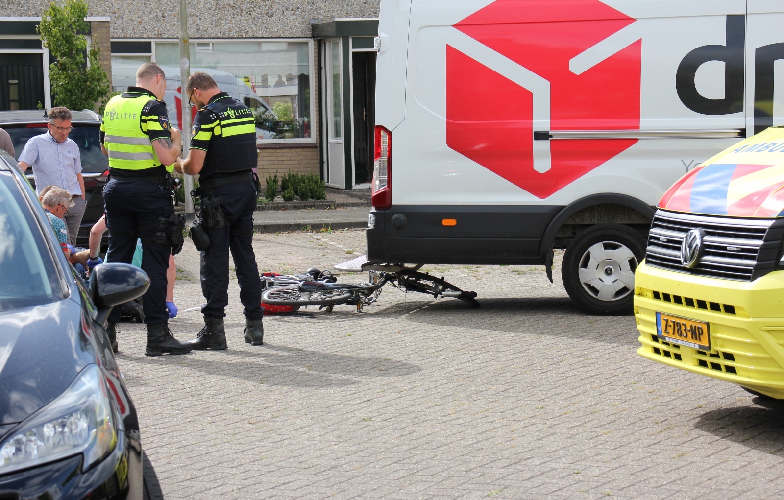 Fietsster onder bestelbus pakketbezorger
