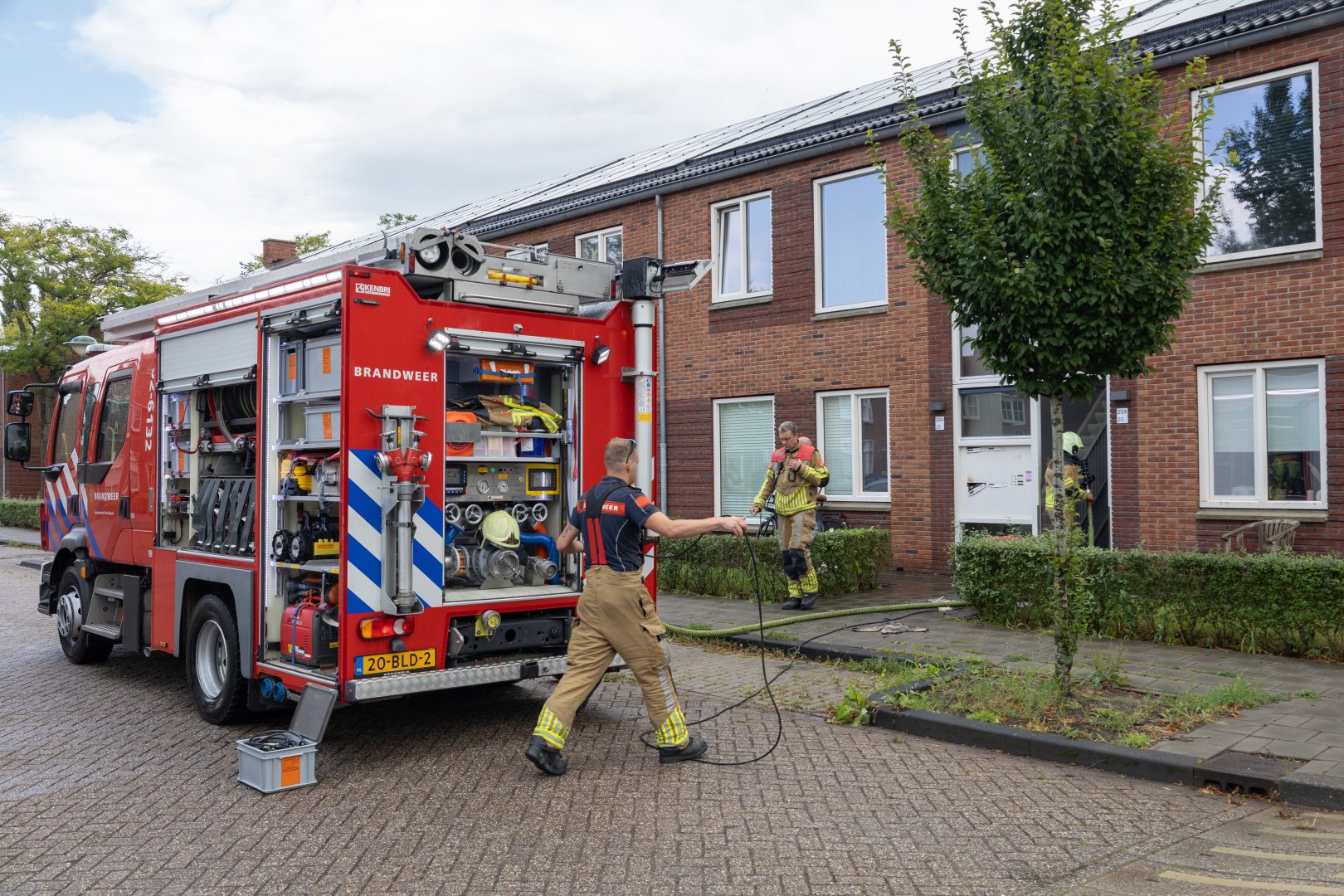 Brandweer blust brand in portiek